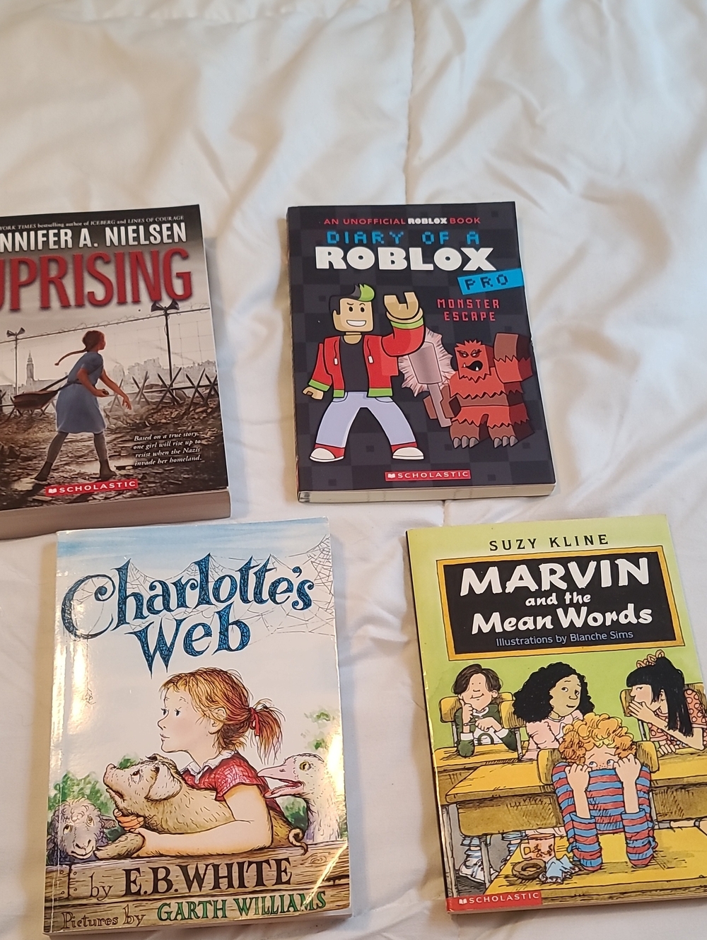 Scholastic Uprising Book Cover with Red, Blue, Black, White